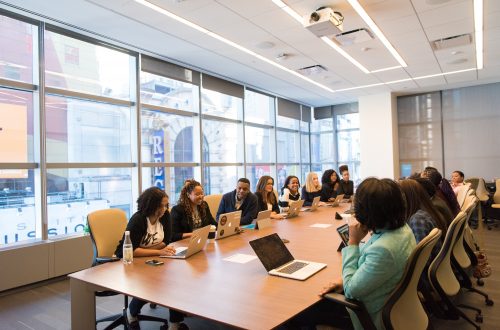 diverse workforce sitting at a conference table in an office