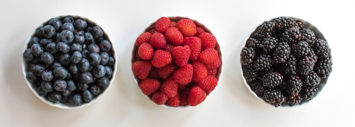 a row of 3 bowls of berries