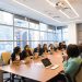 diverse workforce sitting at a conference table in an office